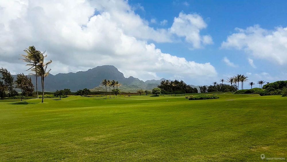 Le sentier longe le green impeccable du Poipu Bay Golf Course.